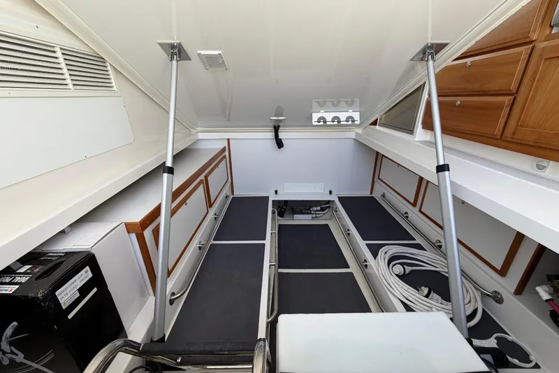 Pivot Yacht Photos Pics 2023 Back Cove 340 interior storage area with organized compartments and equipment.