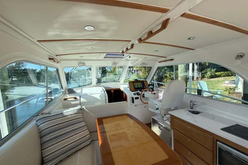 Pivot Yacht Photos Pics Interior of 2023 Back Cove 340 boat with helm, seating, and kitchenette.