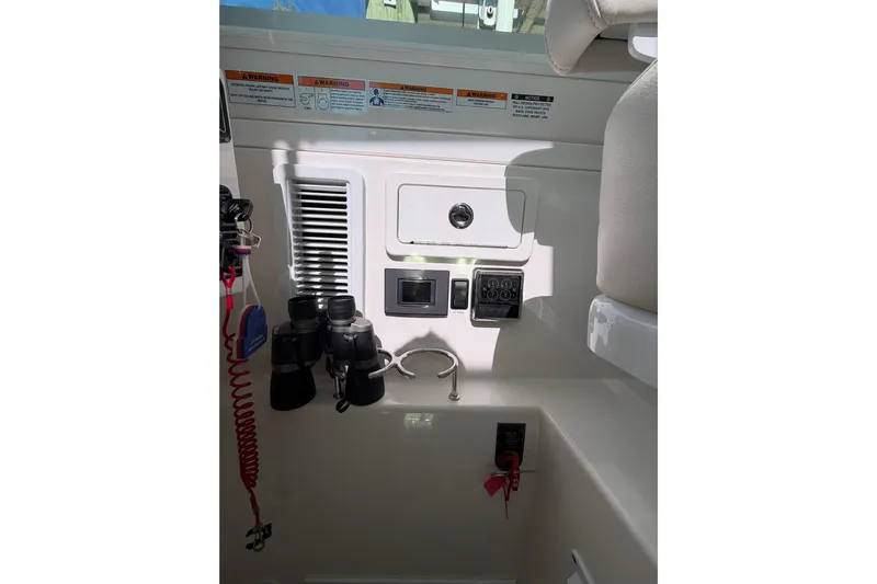 Pivot Yacht Photos Pics 2023 Back Cove 340 boat interior with control panel and binoculars.
