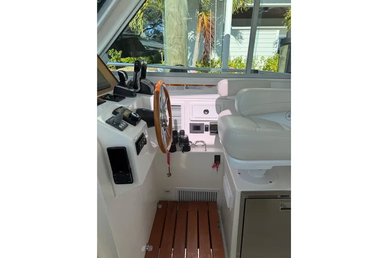 Pivot Yacht Photos Pics 2023 Back Cove 340 helm with wooden steering wheel and modern controls.