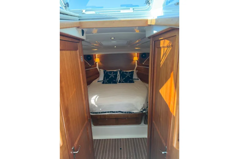 Pivot Yacht Photos Pics Luxurious cabin interior of 2023 Back Cove 340 boat with cozy bedding.