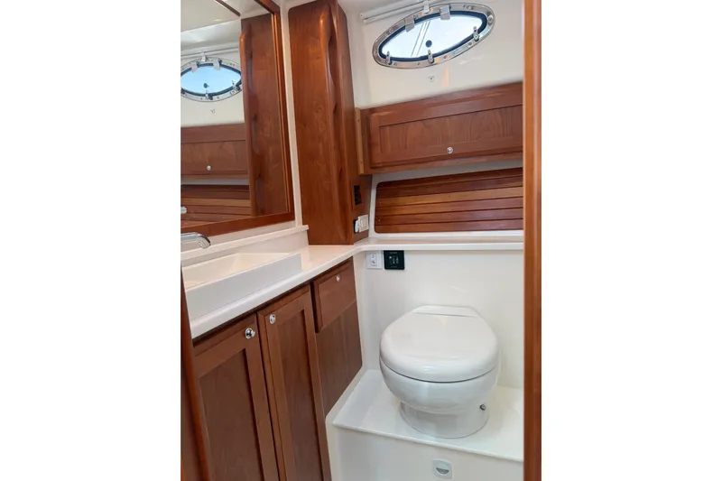 Pivot Yacht Photos Pics 2023 Back Cove 340 yacht bathroom with wooden cabinetry and modern fixtures.