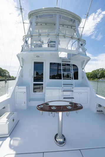 Fortitude Yacht Photos Pics 2001 Hatteras 50 Convertible yacht with spacious deck and ladder, docked by the water.