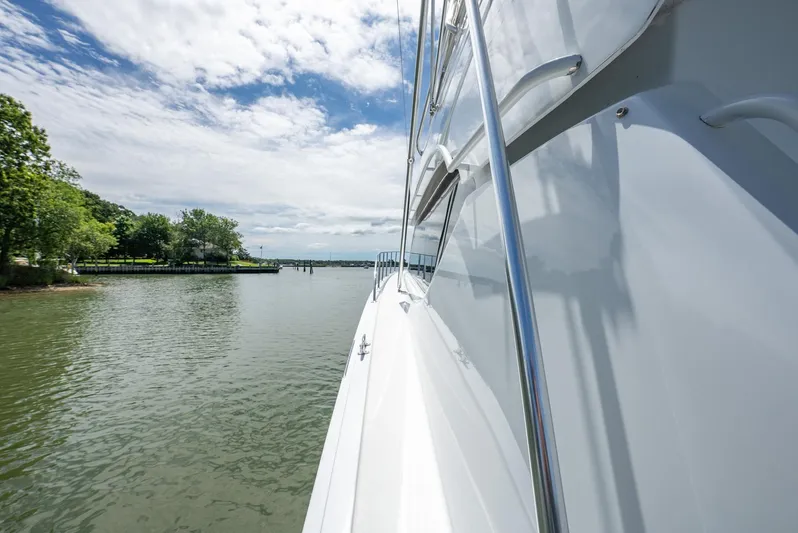 Fortitude Yacht Photos Pics Side view of a 2001 Hatteras 50 Convertible yacht on a calm river.