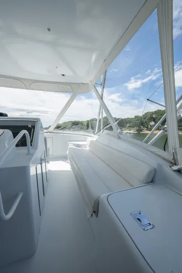 Fortitude Yacht Photos Pics 2001 Hatteras 50 Convertible yacht interior with white seating and clear sky view.