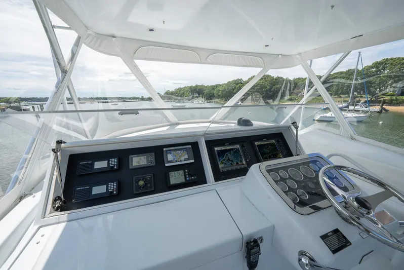 Fortitude Yacht Photos Pics Helm of 2001 Hatteras 50 Convertible yacht with navigation instruments and steering wheel.