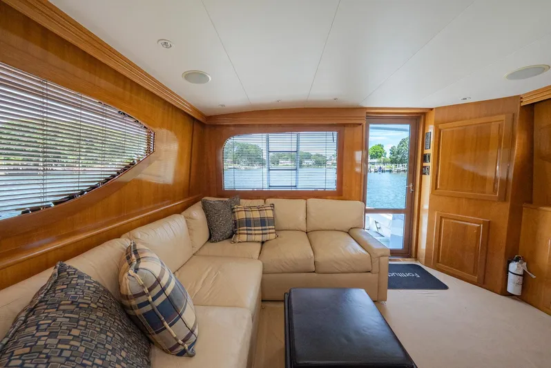Fortitude Yacht Photos Pics Luxurious interior of 2001 Hatteras 50 Convertible yacht with beige leather seating.