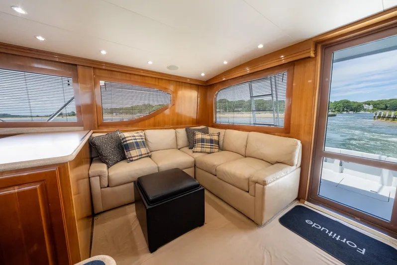 Fortitude Yacht Photos Pics Luxurious interior of 2001 Hatteras 50 Convertible yacht with plush seating and scenic views.