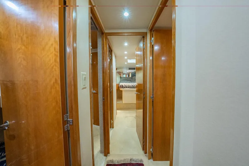 Fortitude Yacht Photos Pics Hallway inside 2001 Hatteras 50 Convertible yacht, featuring wooden doors and modern lighting.