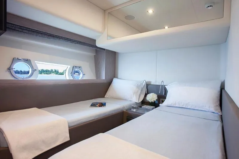 Matsu Yacht Photos Pics Luxurious twin cabin interior of 2018 Ferretti Yachts 650 with porthole windows.