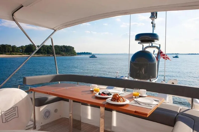 Matsu Yacht Photos Pics Luxurious 2018 Ferretti Yachts 650 with breakfast setup, overlooking serene ocean view.