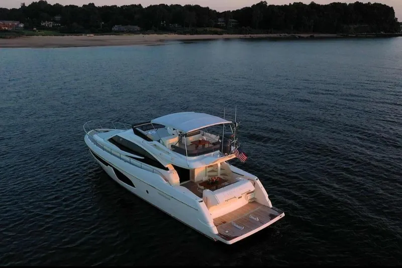 Matsu Yacht Photos Pics 2018 Ferretti Yachts 650 cruising on serene waters at sunset.
