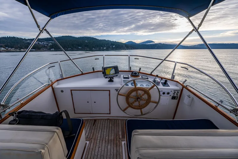 Skagit Song Yacht Photos Pics 1984 Grand Banks 36 Sedan helm with scenic water view at sunset.