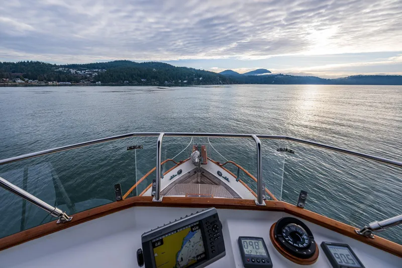 Skagit Song Yacht Photos Pics 1984 Grand Banks 36 Sedan navigating calm waters with scenic mountain views.