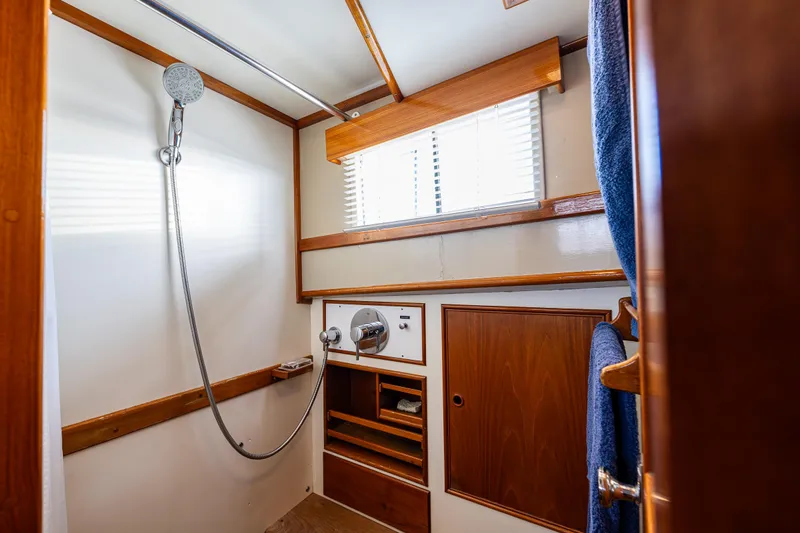 Skagit Song Yacht Photos Pics Shower area in a 1984 Grand Banks 36 Sedan boat with wooden accents.