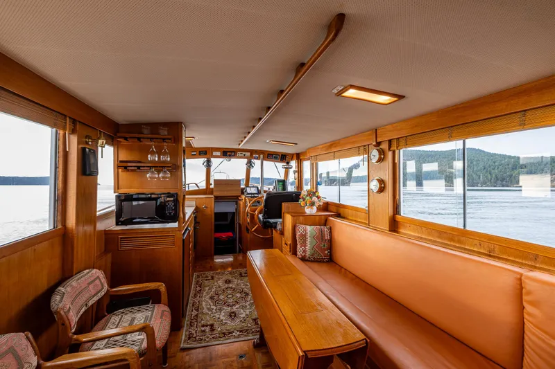 Skagit Song Yacht Photos Pics 1984 Grand Banks 36 Sedan interior with wood finish, seating, and panoramic windows.