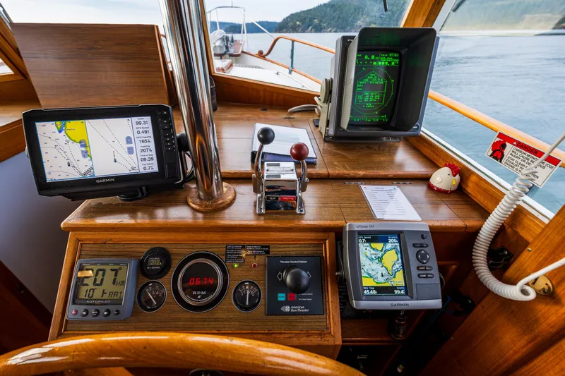 Skagit Song Yacht Photos Pics 1984 Grand Banks 36 Sedan helm with navigation equipment and scenic water view.