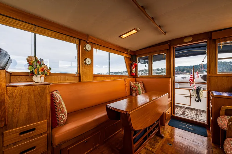Skagit Song Yacht Photos Pics Interior of 1984 Grand Banks 36 Sedan, featuring wooden furnishings and a cozy seating area.