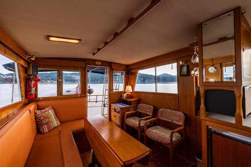 Skagit Song Yacht Photos Pics Interior of 1984 Grand Banks 36 Sedan yacht with wood furnishings and scenic water view.