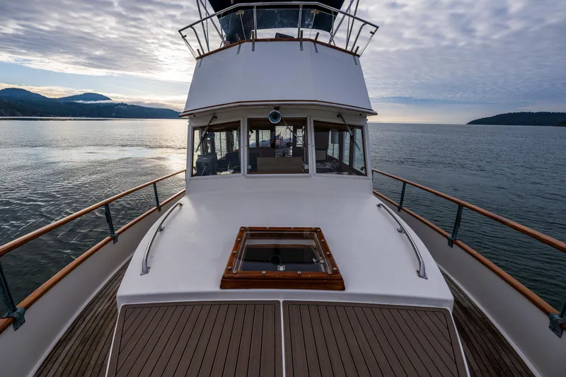 Skagit Song Yacht Photos Pics 1984 Grand Banks 36 Sedan yacht on calm water, showcasing elegant deck and scenic backdrop.