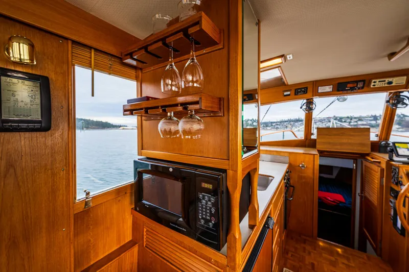 Skagit Song Yacht Photos Pics Interior of 1984 Grand Banks 36 Sedan yacht with wooden cabinetry and kitchen amenities.