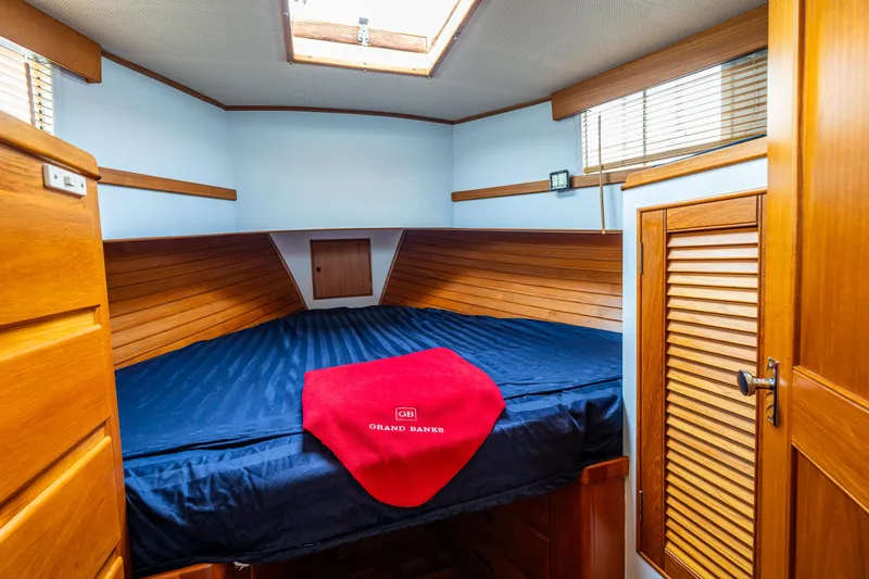 Skagit Song Yacht Photos Pics 1984 Grand Banks 36 Sedan cabin with wooden interior and blue bedding.