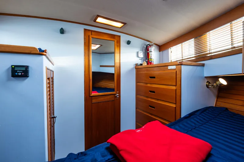 Skagit Song Yacht Photos Pics 1984 Grand Banks 36 Sedan cabin interior with wooden drawers and bed.