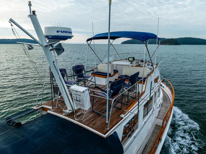 Skagit Song Yacht Photos Pics 1984 Grand Banks 36 Sedan cruising on open water, featuring a spacious deck and canopy.