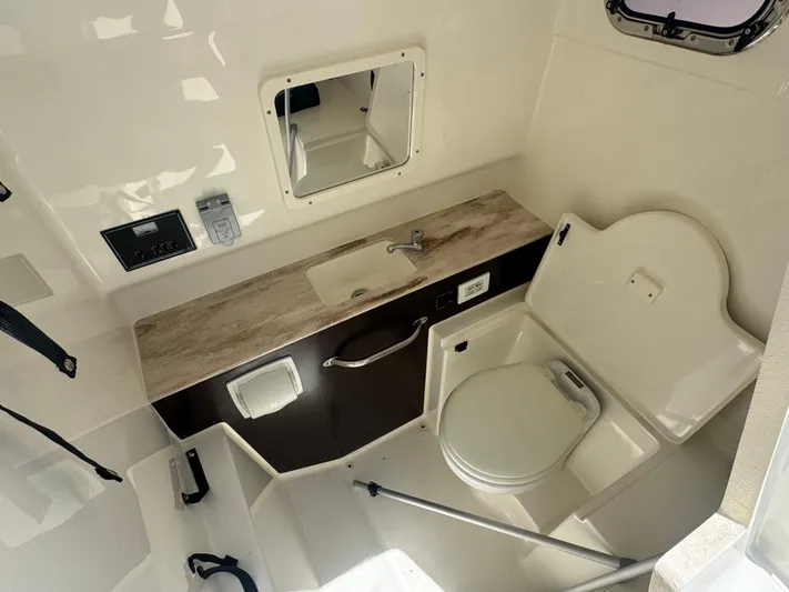  Yacht Photos Pics 2022 Pursuit S 288 Sport boat interior with sink and toilet.