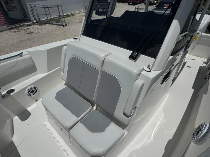  Yacht Photos Pics 2022 Pursuit S 288 Sport boat interior with cushioned seating and speaker.
