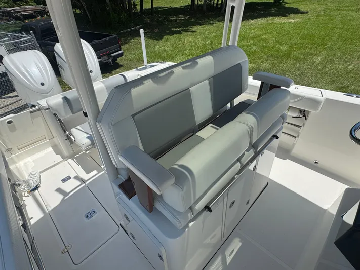  Yacht Photos Pics 2022 Pursuit S 288 Sport boat interior with cushioned seating and dual outboard motors.