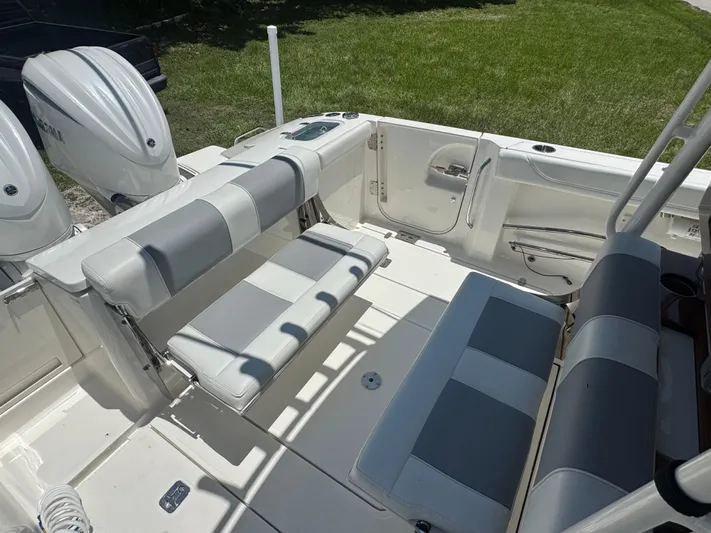  Yacht Photos Pics 2022 Pursuit S 288 Sport boat interior with dual engines and cushioned seating.