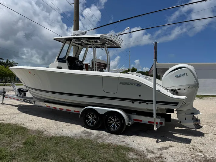  Yacht Photos Pics 2022 Pursuit S 288 Sport boat on trailer with Yamaha engine, parked outdoors.