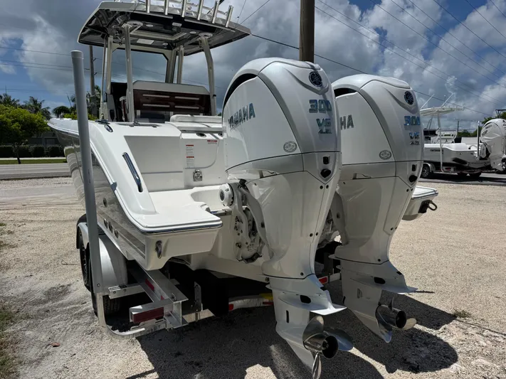  Yacht Photos Pics 2022 Pursuit S 288 Sport boat with dual Yamaha 300 V6 engines, parked on a trailer.