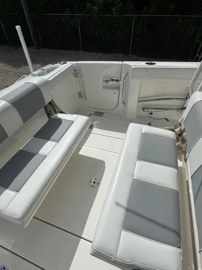  Yacht Photos Pics 2022 Pursuit S 288 Sport boat interior with cushioned seating and sleek design.