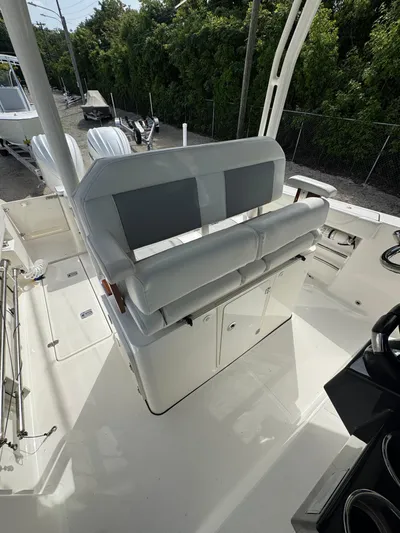  Yacht Photos Pics 2022 Pursuit S 288 Sport boat interior with cushioned seating and storage compartments.