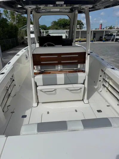  Yacht Photos Pics 2022 Pursuit S 288 Sport boat interior with seating and storage compartments.