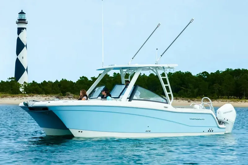  Yacht Photos Pics Manufacturer Provided Image: 2026 World Cat 265 DC-X boat cruising near a lighthouse on calm waters.