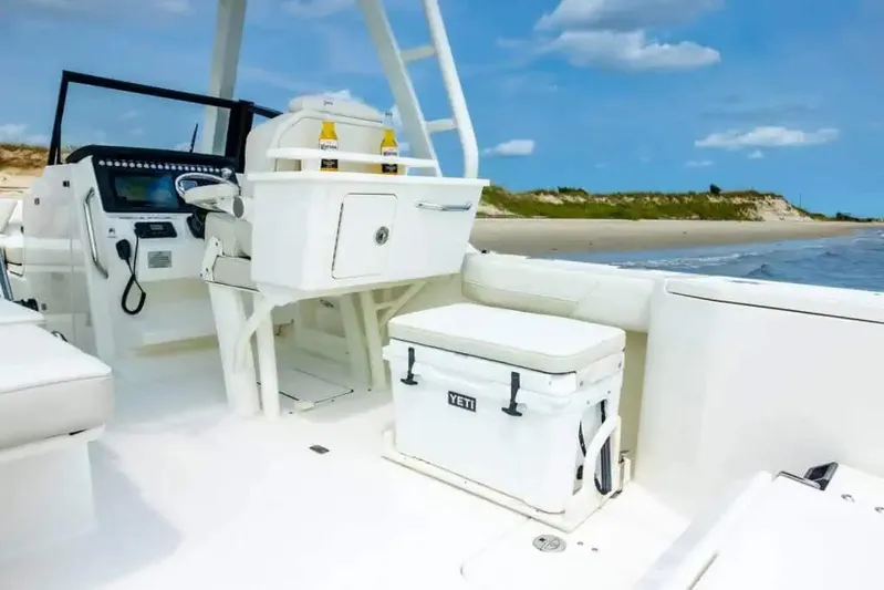  Yacht Photos Pics Manufacturer Provided Image: 2026 World Cat 265 DC-X boat interior with Yeti cooler, beach in background.