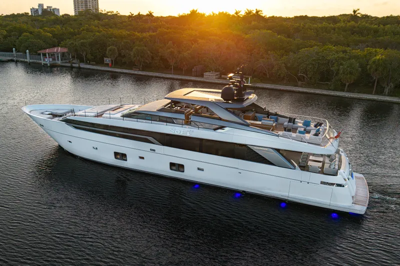 Sofi VI Yacht Photos Pics Luxury 2023 Sanlorenzo SL120A yacht cruising at sunset on a serene waterway.