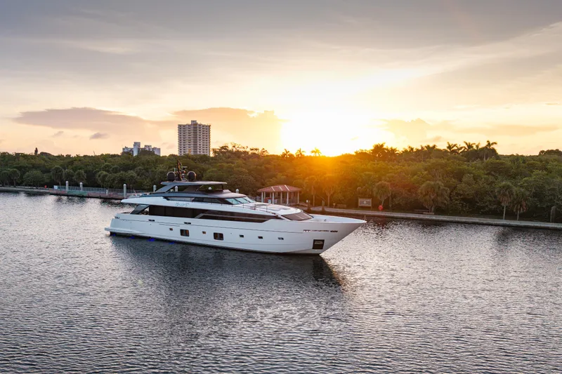 Sofi VI Yacht Photos Pics 2023 Sanlorenzo SL120A yacht cruising at sunset on a serene waterway.