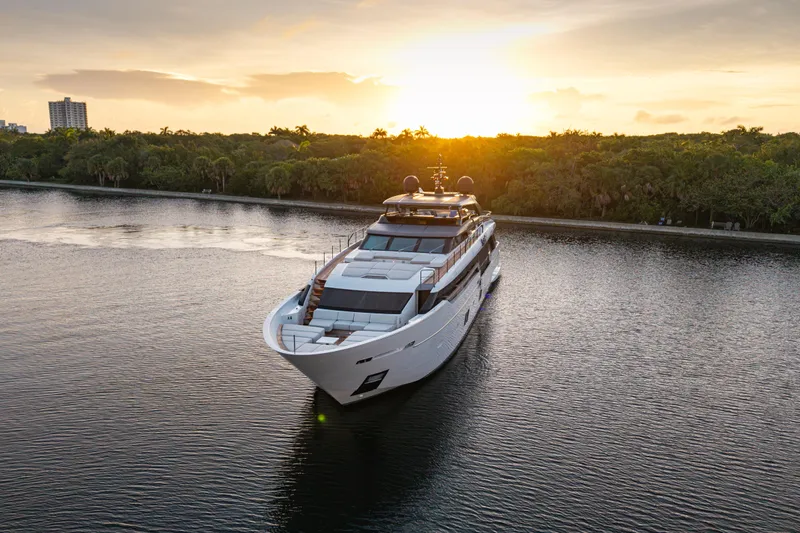 Sofi VI Yacht Photos Pics 2023 Sanlorenzo SL120A yacht cruising at sunset on a serene waterway.