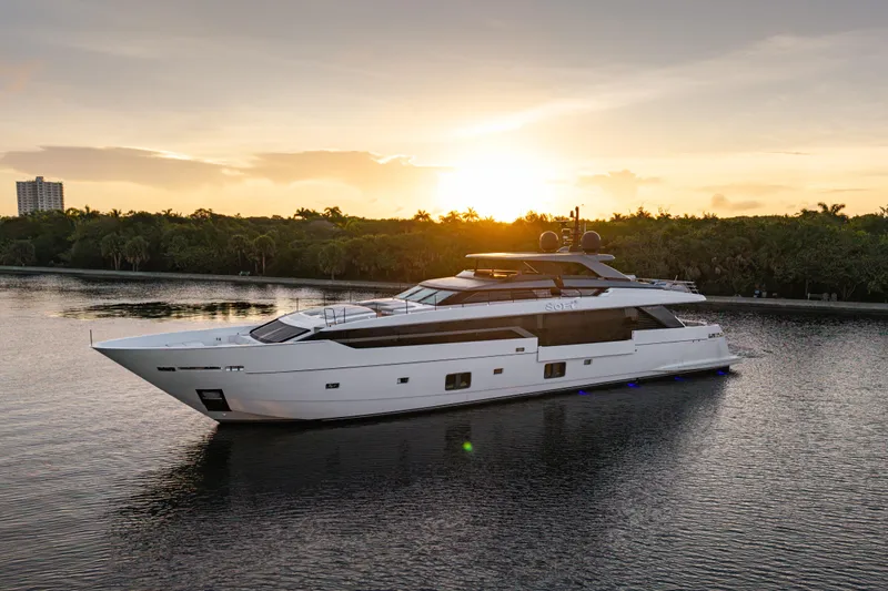 Sofi VI Yacht Photos Pics Luxurious 2023 Sanlorenzo SL 120A yacht cruising at sunset on a serene waterway.