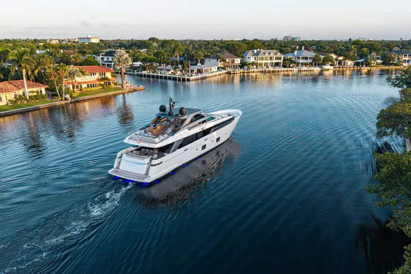 Sofi VI Yacht Photos Pics Luxury 2023 Sanlorenzo SL120A yacht cruising near waterfront homes.