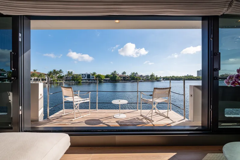 Sofi VI Yacht Photos Pics Luxurious Sanlorenzo SL120A yacht deck with chairs overlooking serene waterfront, 2023 model.