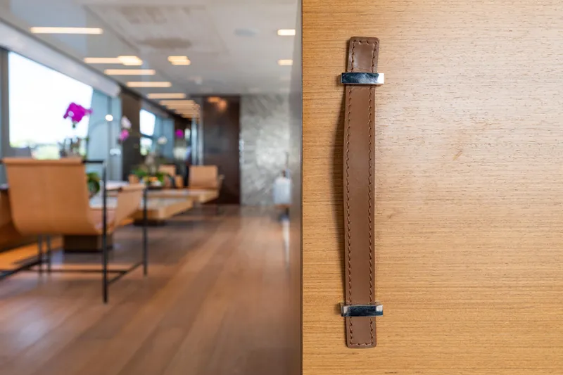 Sofi VI Yacht Photos Pics Luxurious interior of 2023 Sanlorenzo SL120A yacht with elegant leather handle detail.