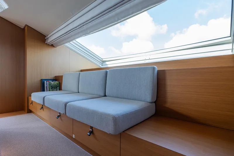 Sofi VI Yacht Photos Pics Modern interior of 2023 Sanlorenzo SL120A yacht with sleek seating and large window.