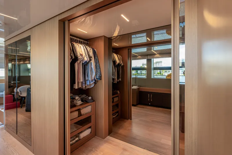 Sofi VI Yacht Photos Pics Luxurious walk-in closet on 2023 Sanlorenzo SL120A yacht, featuring elegant wood finishes.