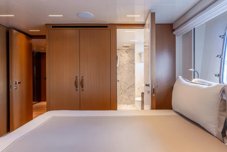 Sofi VI Yacht Photos Pics Luxurious 2023 Sanlorenzo SL120A yacht bedroom with ensuite bathroom and elegant wood finishes.