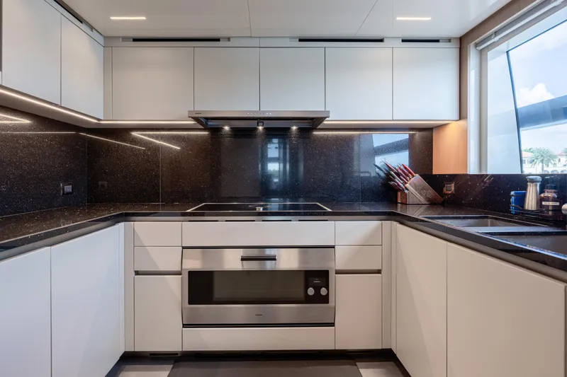Sofi VI Yacht Photos Pics Modern kitchen in 2023 Sanlorenzo SL120A yacht with sleek cabinetry and stainless steel appliances.
